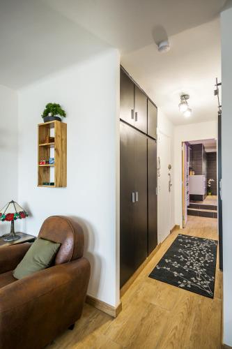 a living room with a couch and a hallway at Escapade en Bord de mer avec Sauna et Spa Privés in Binic-Etables-sur-Mer