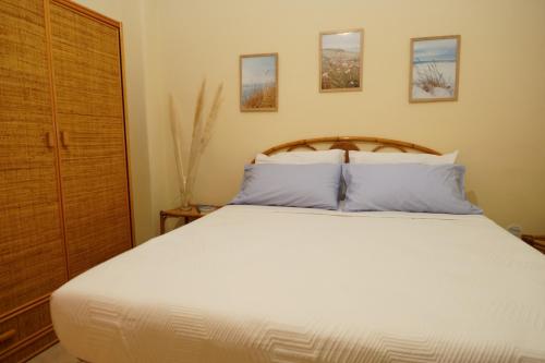 a bedroom with a large white bed with two pillows at Infinito Mare in Acireale