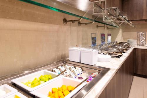 a kitchen with a counter with fruits and food at Residence Inn by Marriott Charlotte Northlake in Charlotte
