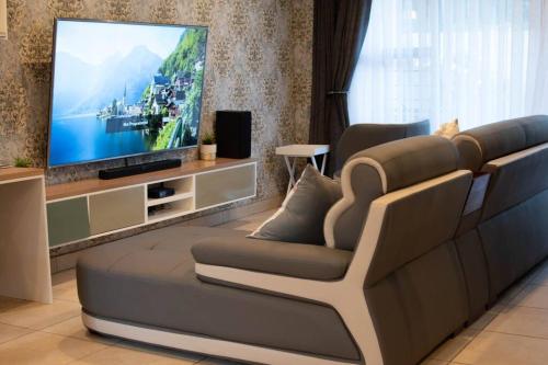 a living room with a couch and a tv at Park Central Apartment in Pretoria
