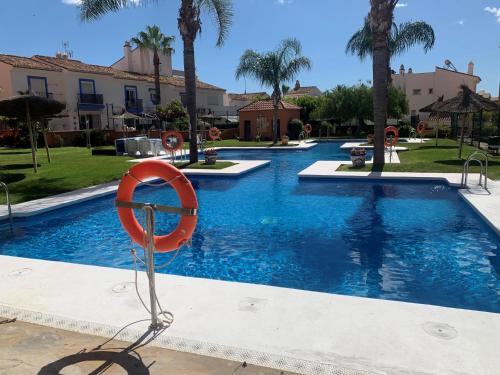 a swimming pool with a life preserver in front of a resort at Los Hidalgos Golf 7 in Manilva