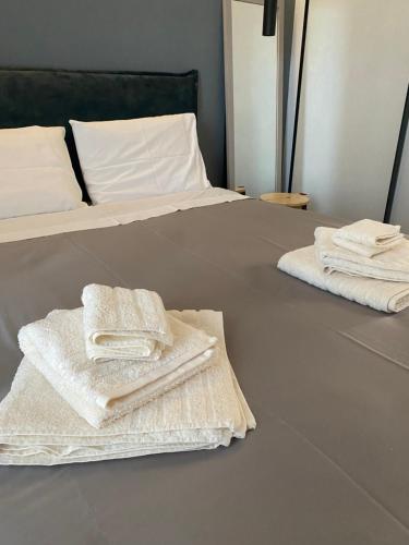 two towels are sitting on top of a bed at Luxury Apartment in Akrata