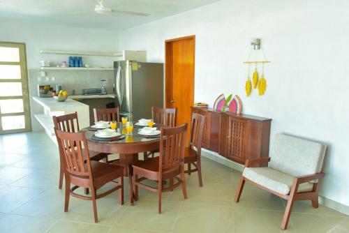 a kitchen and dining room with a table and chairs at Telchac Beach House in Telchac Puerto