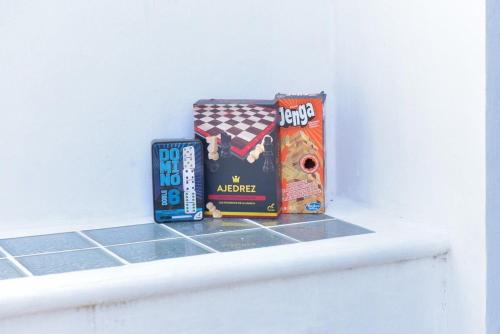 a shelf with three games on top of it at Telchac Beach House in Telchac Puerto