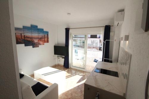 a kitchen with a view of a living room at Sol Marengo Beach in Nerja