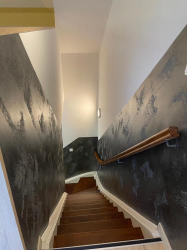 a hallway with stairs and a railing on the wall at Hotel Select Suites & Aparts in Mönchengladbach