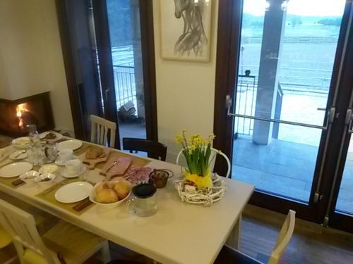 a white table with food on top of it at Agriturismo Cascina del Poggio in Lurago Marinone