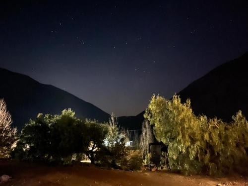 a starry night with trees and mountains in the background at Entre Montañas - Vista Calma in Potrerillos