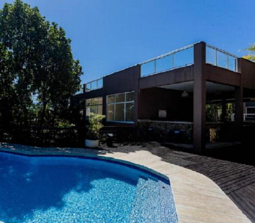 une maison avec une piscine devant dans l'établissement Ilhabela - Praia do Curral - Casa em condomínio, à Ilhabela