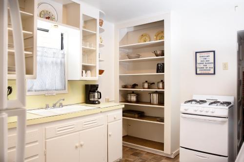 a kitchen with white cabinets and a sink and a stove at June Lake Villager in June Lake