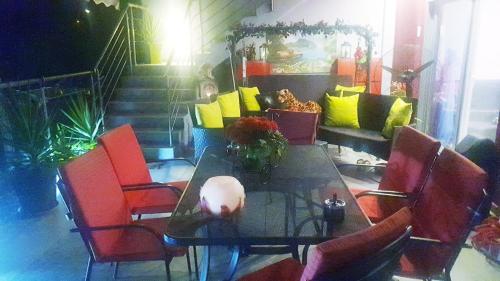 a dining room with a table and red chairs at Perfect Suites in Neos Marmaras