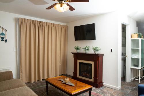 a living room with a fireplace and a tv at June Lake Villager in June Lake