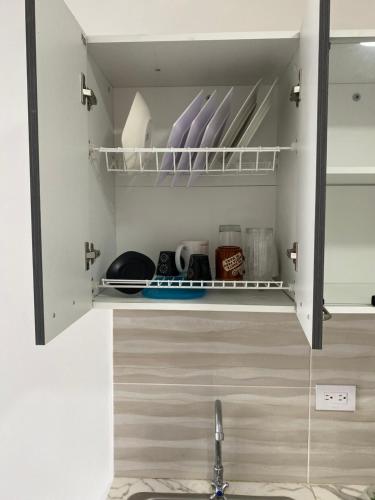 a cupboard with a sink in a kitchen at Cómodo apto 201 muy cerca a C.C. Unicentro Cúcuta in Cúcuta