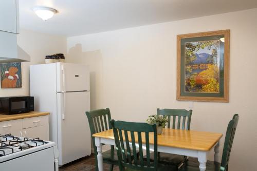 a kitchen with a table and chairs and a refrigerator at June Lake Villager in June Lake