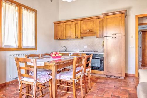 a kitchen with a wooden table and wooden cabinets at Borgo del Faggio - Case Vacanza in Montepulciano