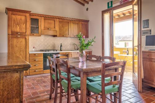 a kitchen with a wooden table and chairs at Borgo del Faggio - Case Vacanza in Montepulciano