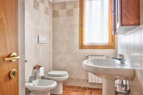 a bathroom with a toilet and a sink at Borgo del Faggio - Case Vacanza in Montepulciano