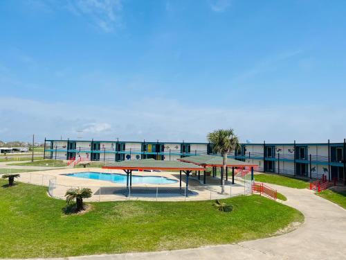 a building with a swimming pool in front of a building at CRYSTAL PALACE RESORT in Bolivar Peninsula