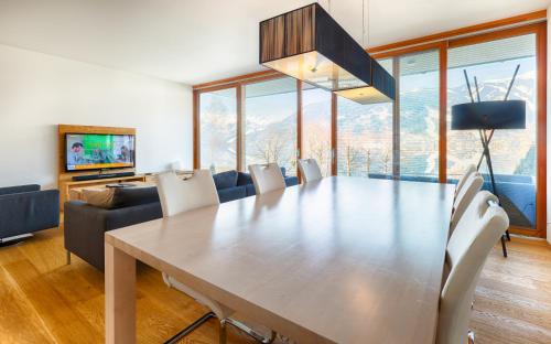 a dining room with a large table and chairs at Residence Bellevue - incl Summercard in Zell am See