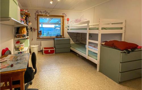 a room with two bunk beds and a desk and a window at Beautiful Home In Hllingsj With Lake View in Hällingsjö