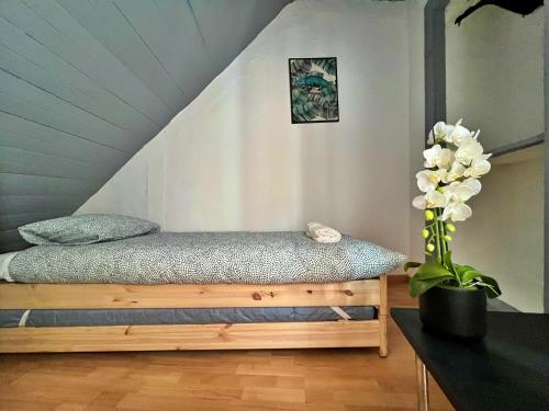 a bedroom with a bed and a vase of flowers at Cosy Mouraria Rooms in Lisbon