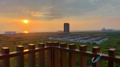 a view of a city from a fence at sunset at Bali Residence Seaview I 2BR I 8-10pax I Waterpark I JonkerSt in Melaka