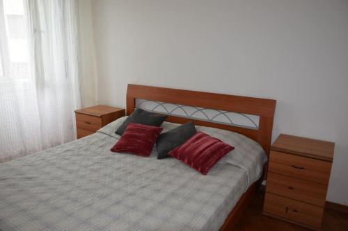 a bedroom with a bed with two red pillows at Frugol nest in Como