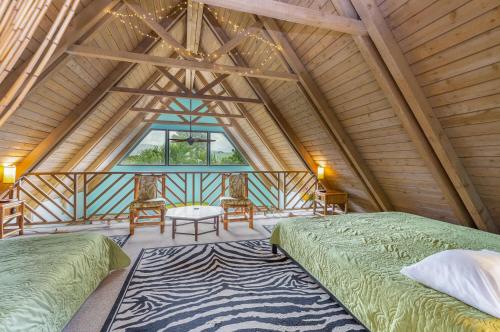 a bedroom with two beds in a room with a large window at Ailana Hale in Princeville