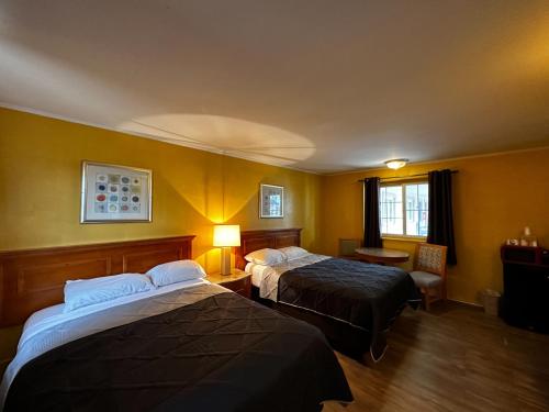 a hotel room with two beds and a window at Skyline Inn in Atlantic City