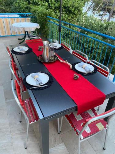 a black table with a red napkin on it at Casa Liliana By the Sea in Mali Lošinj