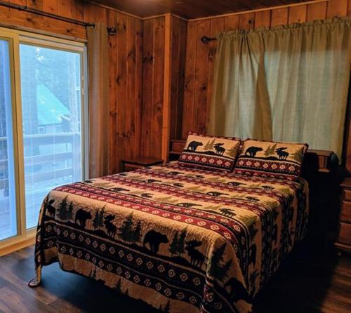 a bedroom with a bed and a window at Cabin #4 in Strawberry