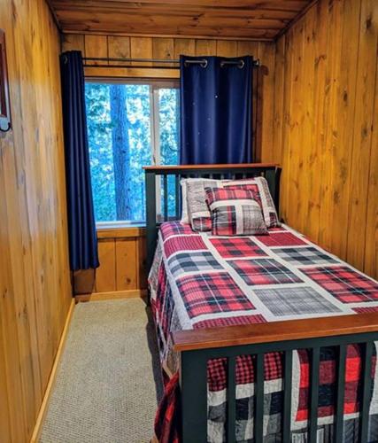 a bedroom with a bed in a wooden cabin at Cabin #4 in Strawberry