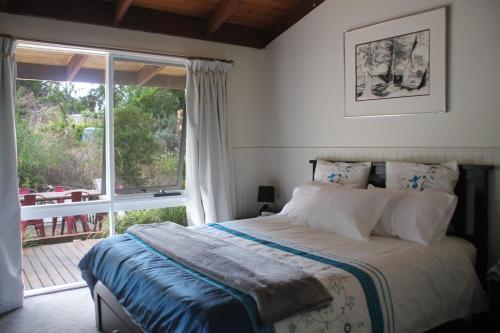 a bedroom with a bed and a large window at Yackandandah farm homestead in Yackandandah