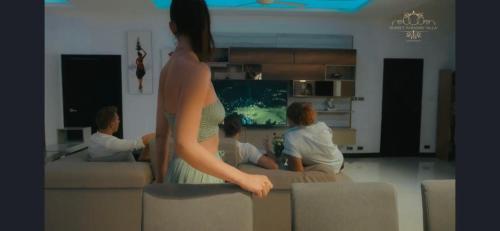 a woman standing on a couch in a living room at Sunset Paradise Villa in Haad Pleayleam