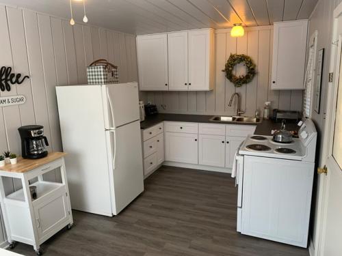 a kitchen with white appliances and a white refrigerator at Cabin #6 in Strawberry
