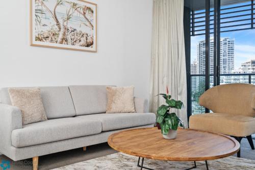 a living room with a couch and a table at Oracle Resort Broadbeach - gclr in Gold Coast