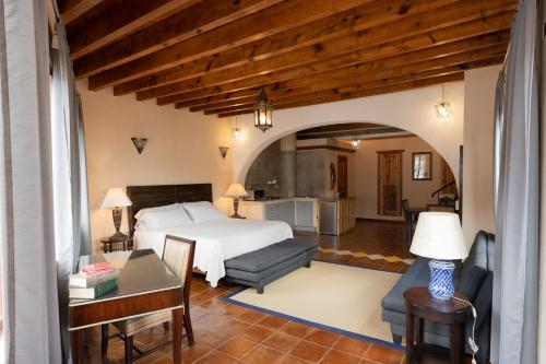 a bedroom with a bed and a living room at La Casa Veintidós in Guanajuato