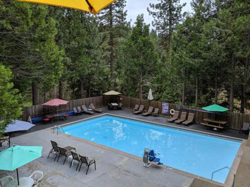 a large swimming pool with chairs and umbrellas at Cabin #10 in Strawberry