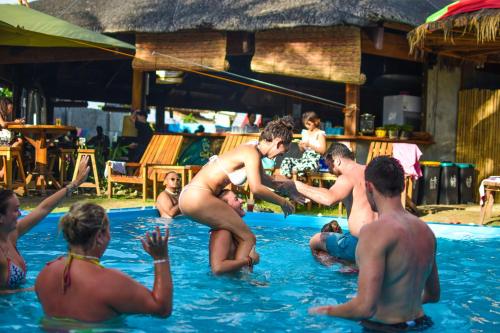 a group of people in the swimming pool at Mad Monkey Hostel Siargao in General Luna