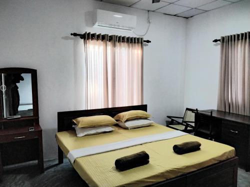 a bedroom with a bed with a dresser and a mirror at The Esence of Sri Lanka in Ahungalla