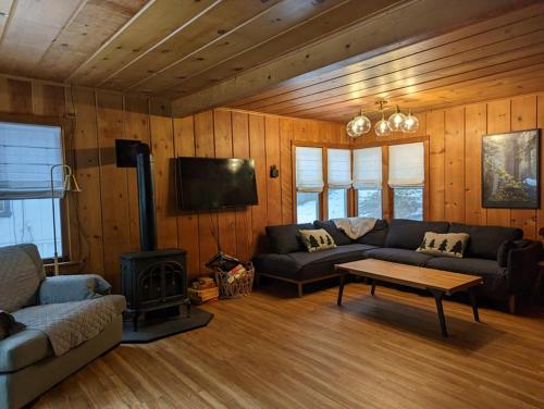 a living room with a couch and a stove at Cabin #8 in Strawberry