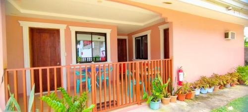 a house with plants on the front porch at RNA Guesthouse in Moalboal