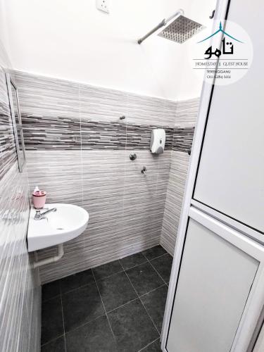 a bathroom with a sink and a shower at Tamu Homestay Terengganu in Kuala Terengganu