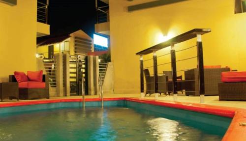 a swimming pool in the middle of a house at Wayak Hotel in Managua