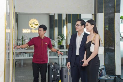 a group of three people standing in front of a store at Hotel Soco in Da Nang