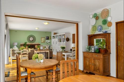 a kitchen and dining room with a table and chairs at Valley Heights Guest House and B & B in Cape Town