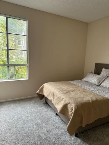 a bedroom with a bed and a window at Stylish Apartment in the Heart of Los Angeles in Los Angeles