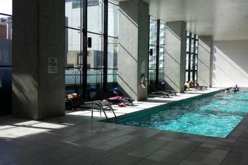 a swimming pool in a building with people in it at ◈Melbourne CBD 2Br 2Bth Apt Indoor Pool & balcony◈ in Melbourne