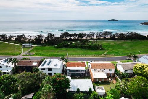 an aerial view of a house and the ocean at Surfs Up! Oceanfront Home Sleeps 6 steps from the sand in Emerald Beach