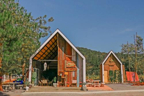 a small wooden church with benches and tables at Yellowstone Camps Resort Khao Yai in Pak Chong